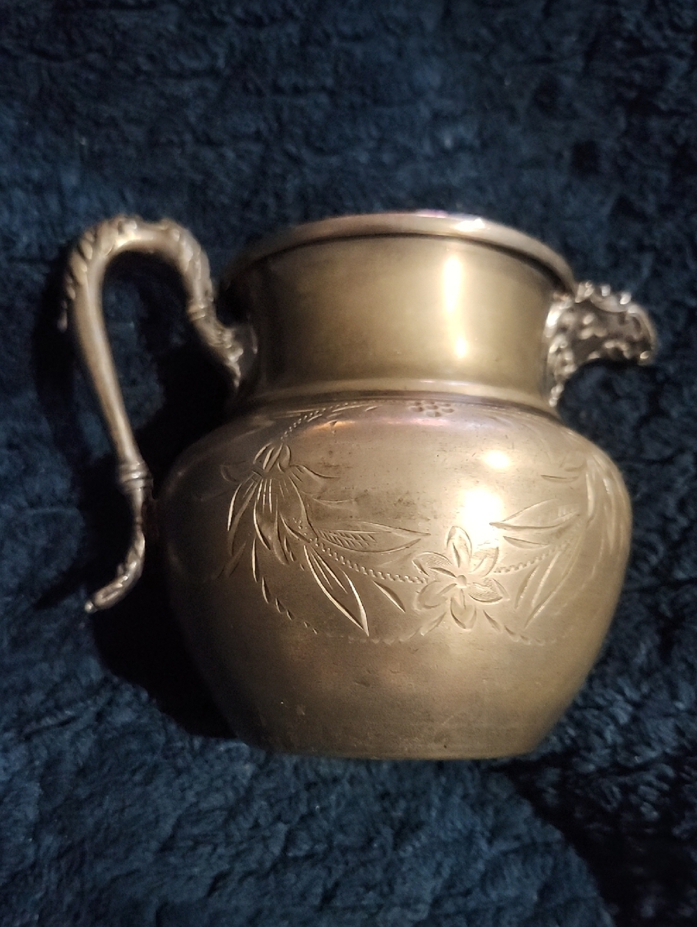 vintage antique item is a silver-plated creamer jug